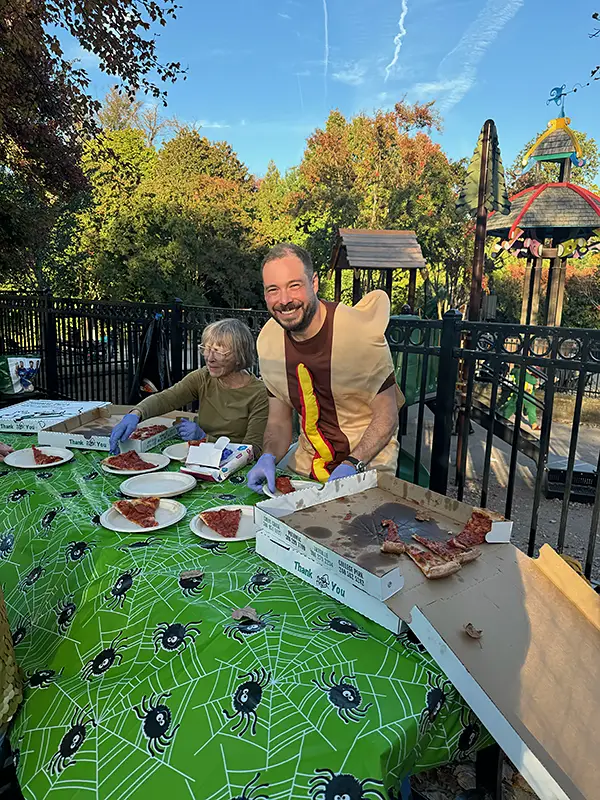 Serving pizza at Halloween parade
